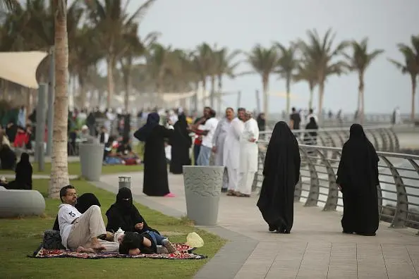JEDDAH, SAUDI ARABIA - JUNE 22: People, many of them wearing traditional Saudi garments, walk along the Corniche waterfront on June 22, 2018 in Jeddah, Saudi Arabia. The Saudi government, under Crown Prince Mohammad Bin Salman, is phasing in an ongoing series of reforms to both diversify the Saudi economy and to liberalize its society. The reforms also seek to empower women by restoring them basic legal rights, allowing them increasing independence and encouraging their participation in the workforce. Saudi Arabia is among the most conservative countries in the world and women have traditionally had much fewer rights than men. (Photo by Sean Gallup/Getty Images) , Getty Images/Getty Images