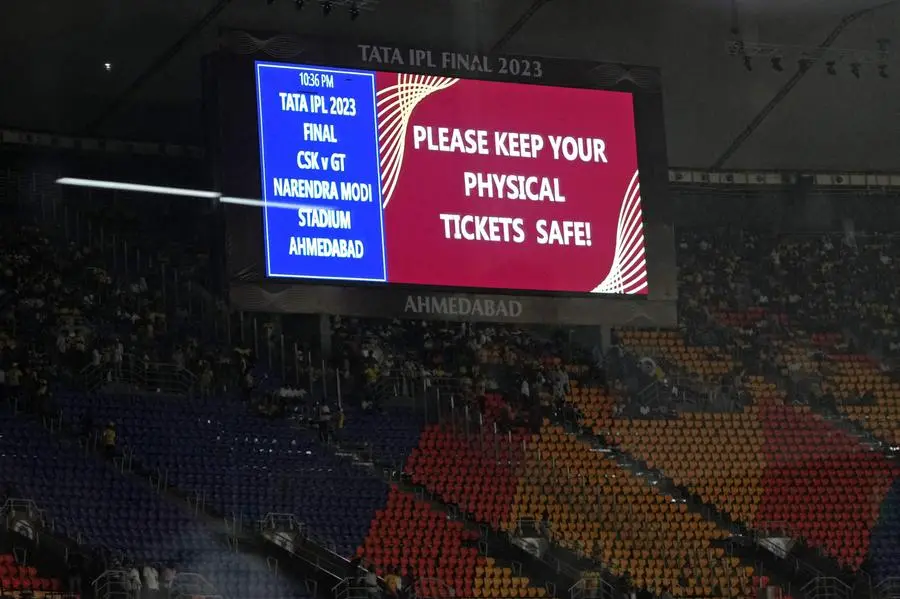 A digital board displays a message after the match got delayed due to rain before the start of the Indian Premier League (IPL) Twenty20 final cricket match between Gujarat Titans and Chennai Super Kings at the Narendra Modi Stadium in Ahmedabad on May 28, 2023. (Photo by Sajjad HUSSAIN / AFP)