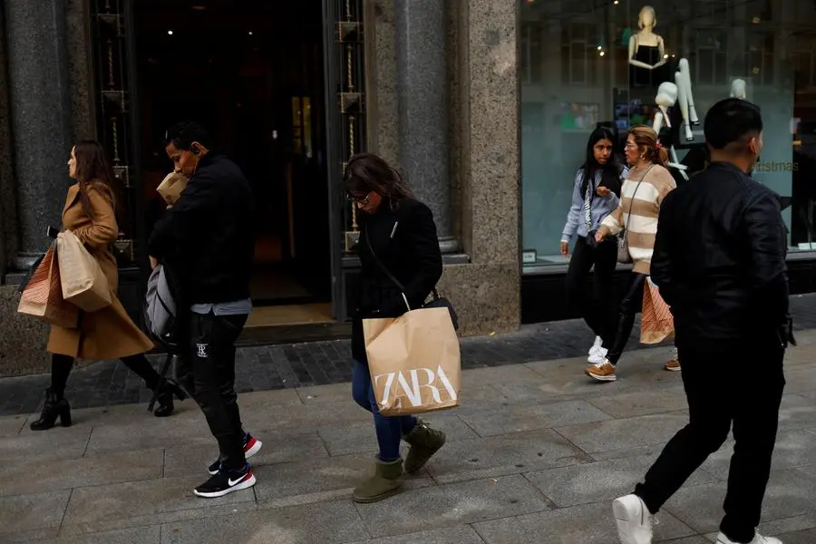 People walk past a Zara store in central Madrid, Spain, December 11, 2023. REUTERS/Susana Vera