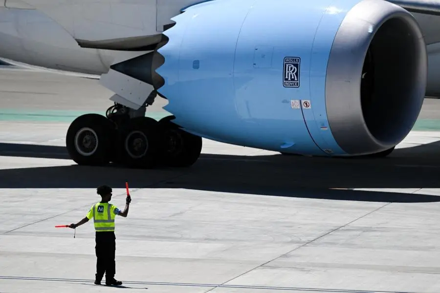 A wing walker directs Norse Atlantic Airways Boeing 787-9 aircraft with Rolls Royce engines as it is pushed back from a gate carrying passengers on an inaugural flight to Oslo, Norway from Los Angeles International Airport (LAX) in Los Angeles, California, on August 10, 2022. (Photo by Patrick T. FALLON / AFP) , AFP