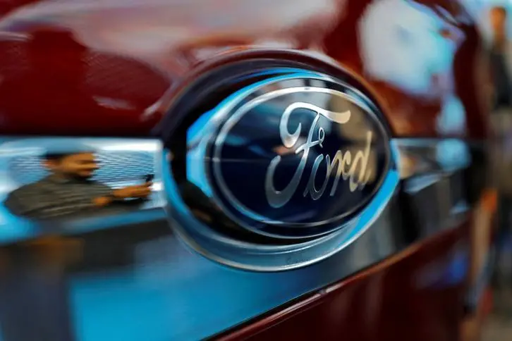 FILE PHOTO: A visitor is reflected as he takes pictures of a new Ford Aspire car during its launch in New Delhi, India, October 4, 2018. REUTERS/Anushree Fadnavis/File Photo GLOBAL BUSINESS WEEK AHEAD , Reuters Images/REUTERS