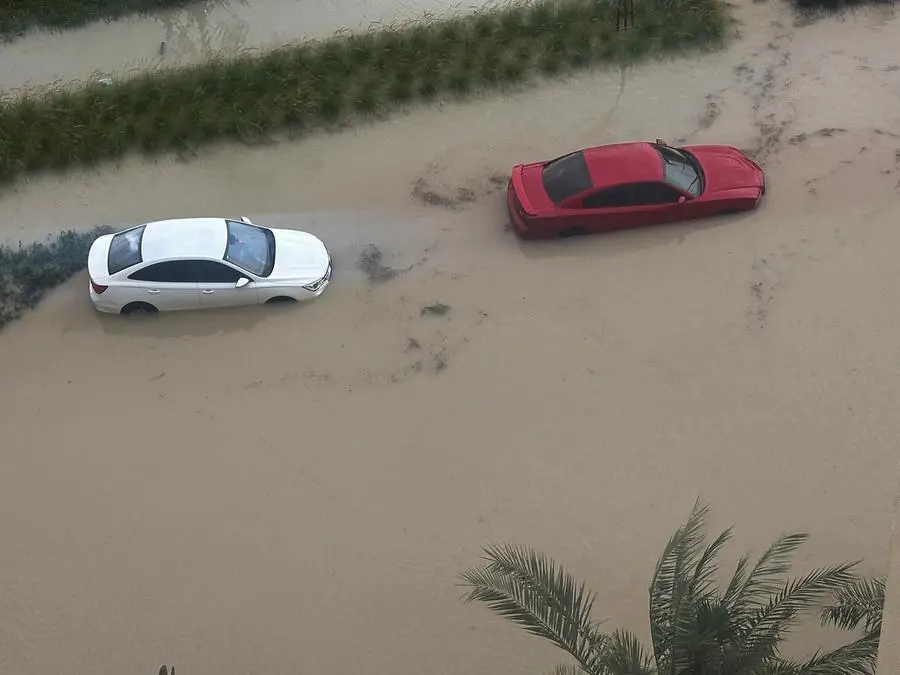 Cars are parked at a flooded street during a rain storm in Dubai, United Arab Emirates, April 16, 2024. REUTERS/Abdel Hadi Ramahi