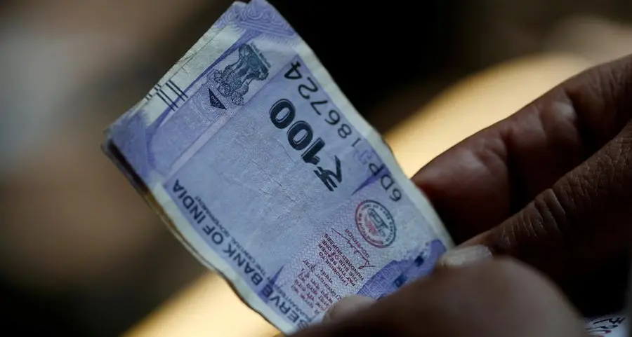 Indian rupee slips to record low, central bank intervention curbs fall