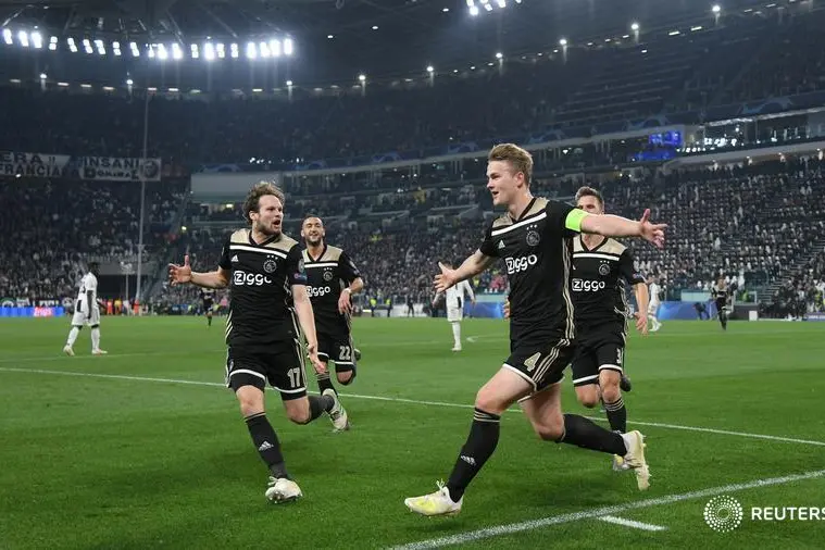 FILE PHOTO: Soccer Football - Champions League Quarter Final Second Leg - Juventus v Ajax Amsterdam - Allianz Stadium, Turin, Italy - April 16, 2019 Ajax\\'s Matthijs de Ligt celebrates scoring their second goal with Daley Blind and team mates REUTERS/Alberto Lingria/File Photo - RC1ABB2F40D0 , Reuters Images