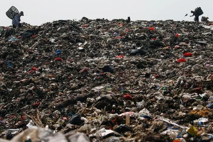 A group of scavengers search for recyclable items in order to sell them, amid the coronavirus disease (COVID-19) pandemic, at Bantar Gebang landfill in Bekasi, on the outskirts of Jakarta, Indonesia, June 5, 2021. REUTERS/Ajeng Dinar Ulfiana TPX IMAGES OF THE DAY , REUTERS