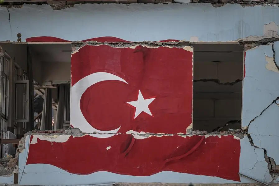 A painted Turkish national flag is seen on the wall of a collapsed building, two months after a 7.8-magnitude jolt and its aftershocks wiped out swathes of Turkey\\'s mountainous southeast, in Antakya on April 5, 2023. (Photo by OZAN KOSE / AFP) Image used for illustrative purpose.