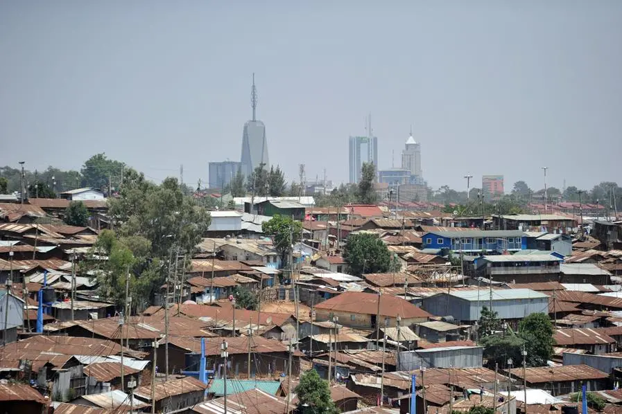 Photo made January 16, 2018: Modern highrise office blocks break the skyline above the sprawling Kibera slum in the foreground in the Kenyan capital, Nairobi. AFP PHOTO/Tony KARUMBA