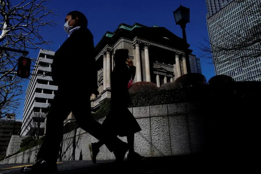 FILE PHOTO: Pedestrians walk past the Bank of Japan building in Tokyo, Japan March 18, 2024. REUTERS/Kim Kyung-Hoon/File Photo , Reuters/REUTERS