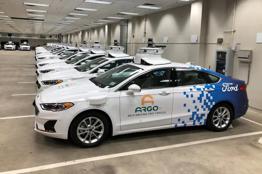 FILE PHOTO: A row of Ford Fusion Hybrid sedans outfitted with sensors and other self-driving equipment in Argo\\u2019s test garage in Pittsburgh, Pennsylvania, U.S. September 19, 2019. REUTERS/Paul Lienert/File Photo