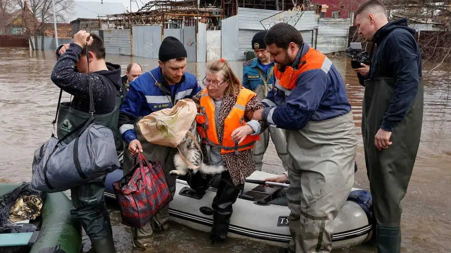 Russians flee floods in boats clutching valuables, food, pets