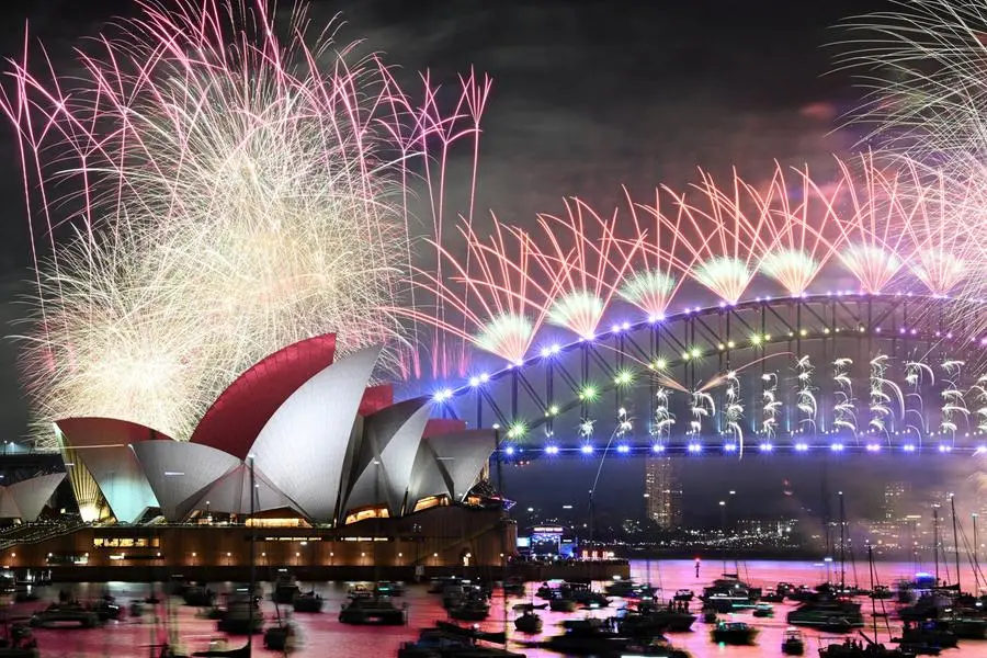 Fireworks are seen over the Sydney Opera House and Harbour Bridge during New Year's Eve celebrations in Sydney, Australia January 1, 2024. AAP Image/Dan Himbrechts via REUTERS