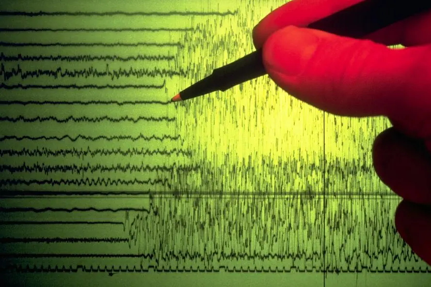 A seismographer uses a pen to point out the initial shock waves of an earthquake charted on a seismograph. Getty ImagesImage used for illustrative purpose. , Getty Images
