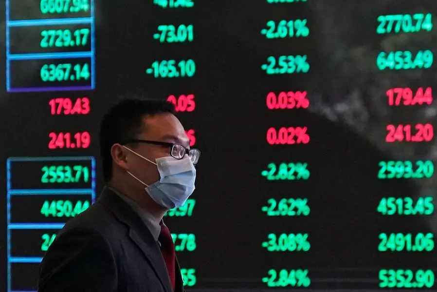FILE PHOTO: A man wearing a protective mask is seen inside the Shanghai Stock Exchange building, as the country is hit by a new coronavirus outbreak, at the Pudong financial district in Shanghai, China February 28, 2020. REUTERS/Aly Song/File Photo , Reuters/REUTERS