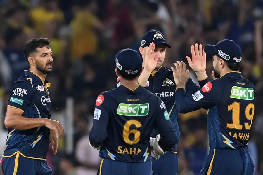 Gujarat Titans' players celebrate after the dismissal of Chennai Super Kings' captain Mahendra Singh Dhoni (not pictured) during the Indian Premier League (IPL) Twenty20 final cricket match between Gujarat Titans and Chennai Super Kings at the Narendra Modi Stadium in Ahmedabad on May 30, 2023. (Photo by Sajjad HUSSAIN / AFP)