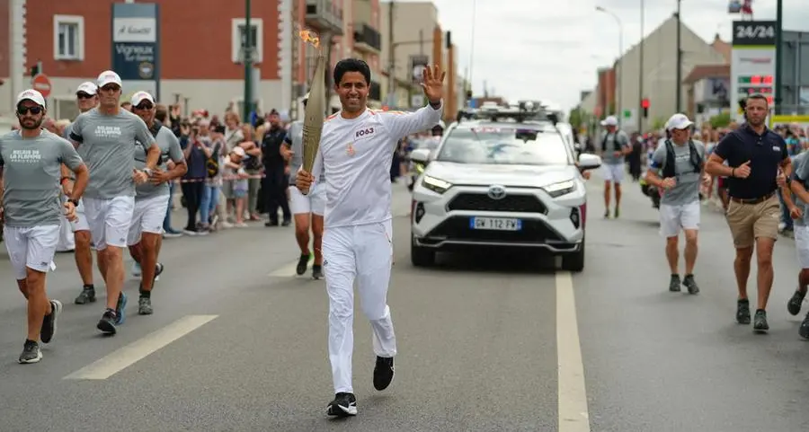 PSG President Nasser Al-Khelaïfi takes part in Olympic torch relay in Paris ahead of opening ceremony
