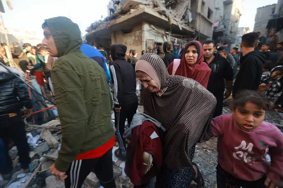 EDITORS NOTE: Graphic content / Palestinians rush out of a bombarded area in the Rafah refugee camp in the southern Gaza Strip on December 1, 2023, as fighting resumed shortly after the expiration of a seven-day truce between Israel and Hamas militants. A temporary truce between Israel and Hamas expired on December 1, with the Israeli army saying combat operations had resumed, accusing Hamas of violating the operational pause. (Photo by MOHAMMED ABED / AFP) , Agence France-Presse (AFP)/AFP