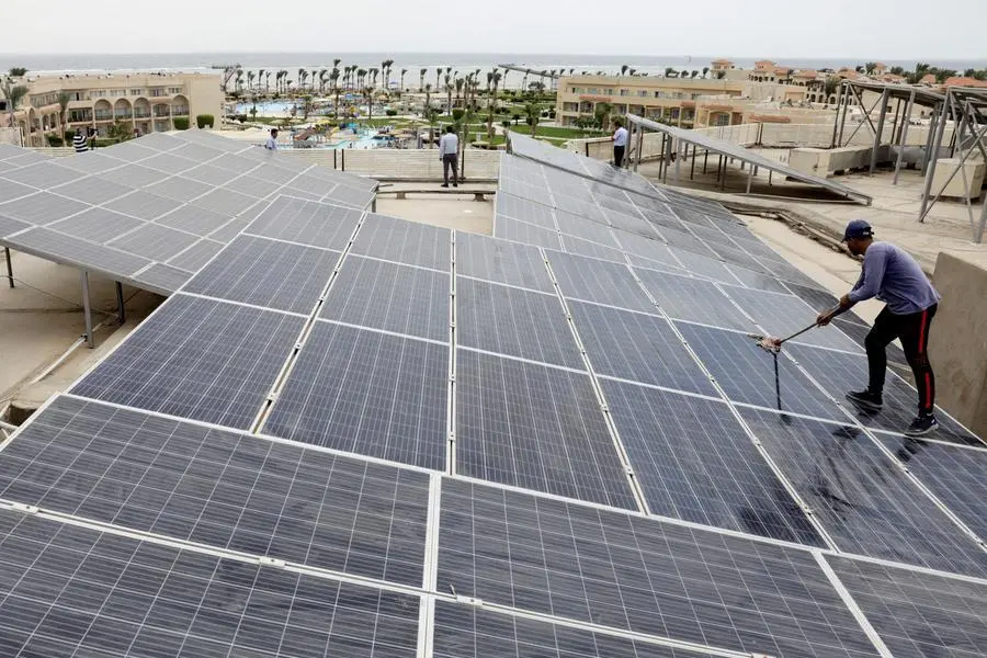 A worker cleans solar cells on a rooftop of a hotel in the resort town of Sharm el-Sheikh, the first to operate a solar-powered plant in a bid to turn to clean energy as the city prepares to host the upcoming COP27 summit in November, in Sharm el-Sheikh, Egypt, June 4, 2022. Picture taken June 4, 2022. REUTERS/Mohamed Abd El Ghany , Reuters/REUTERS