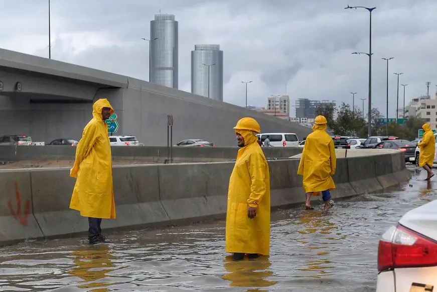 People walk through flood water following heavy rain, in Jeddah, Saudi Arabia, November 24, 2022. Saudi Press Agency/Handout via REUTERS