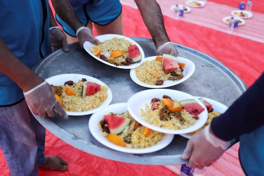 Volunteers prepare meals at a charity Iftar camp ahead of sunset \\u201CMaghrib\\u201D prayers during the month of Ramadan in Dubai, United Arab Emirates, March 29, 2023. REUTERS/Amr Alfiky , Reuters