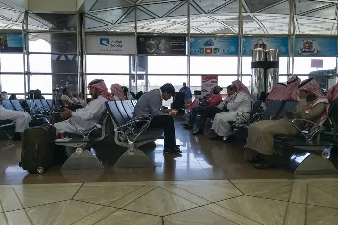 Riyadh, Saudi Arabia - October 22, 2014: Group of saudi men in traditional outfit, waiting at the gates, in the riyadh airport. Getty Images