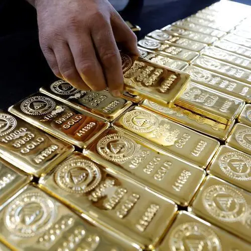 Gold falls on stronger dollar after Trump says he won't fire Powell