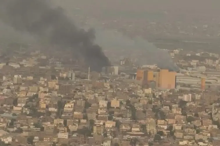 A drone view shows smoke rising over the Khartoum North Light Industrial Area, in Bahri, Sudan, April 23, 2023, in this still image taken from video obtained by Reuters. Video obtained by Reuters/ via REUTERS , Reuters