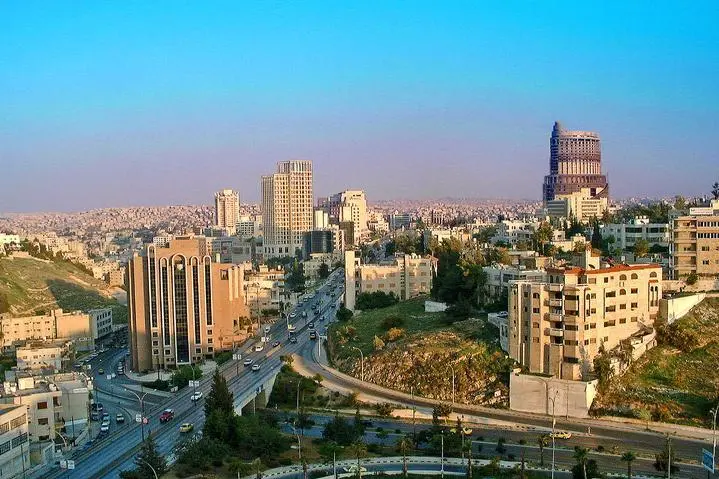 Image used for illustrative purpose. High Angle View Of City Lit Up Against Blue Sky Photo Taken In Amman, Jordan. Getty Images , Getty Images