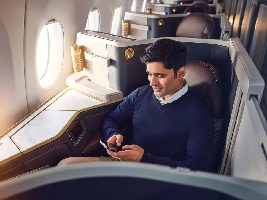 Etihad Airways Business Class with guest taking advantage of Etihad's unlimited Wi-fly. Image courtesy: Etihad Airways
