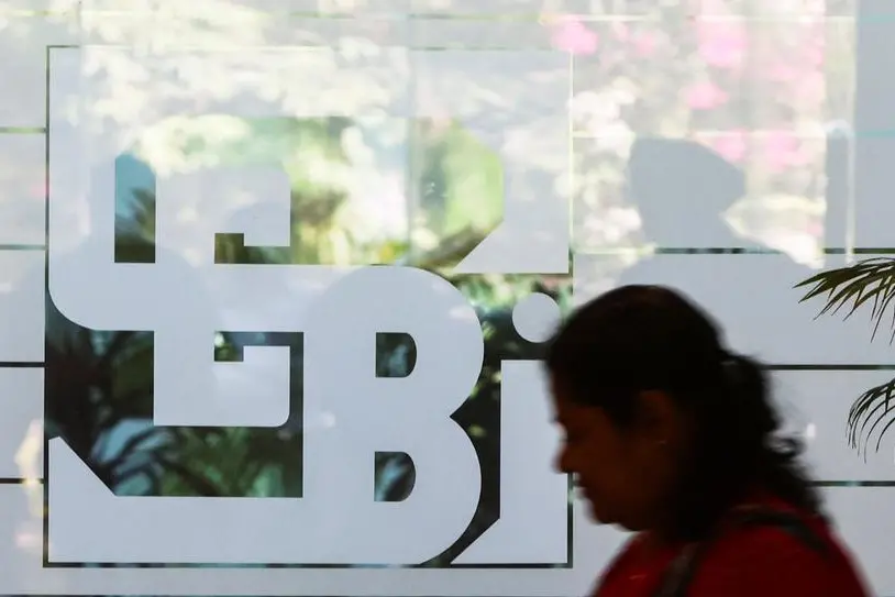 A woman walks past the logo of the Securities and Exchange Board of India (SEBI), at its headquarters in Mumbai, India, May 27, 2022. REUTERS/Francis Mascarenhas Image for illustrative purpose.