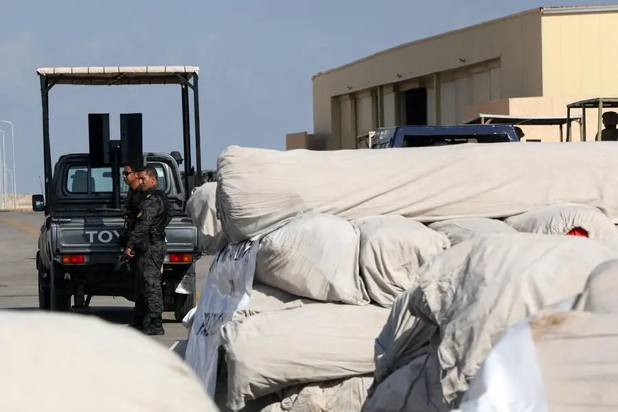 Egyptian police officers stand next to humanitarian aid for Palestinians as it waits for the reopening of the Rafah border crossing on the Egyptian side to enter Gaza, amid the ongoing conflict between Israel and the Palestinian Islamist group Hamas, at Al Arish airport, Egypt October 20, 2023. REUTERS/Amr Abdallah Dalsh , Reuters