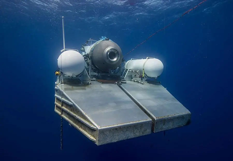 This undated image courtesy of OceanGate Expeditions, shows their Titan submersible on a platform awaiting signal to dive. - Rescue teams expanded their search underwater on June 20, 2023, as they raced against time to find a Titan deep-diving tourist submersible that went missing near the wreck of the Titanic with five people on board and limited oxygen. All communication was lost with the 21-foot (6.5-meter) Titan craft during a descent June 18 to the Titanic, which sits at a depth of crushing pressure more than two miles (nearly four kilometers) below the surface of the North Atlantic. (Photo by Handout / OceanGate Expeditions / AFP)