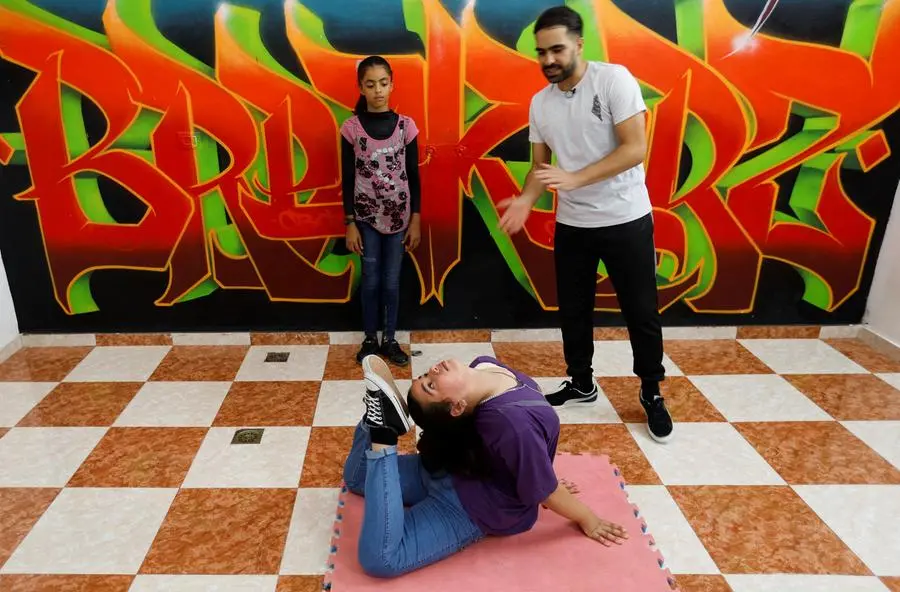 A Palestinian trainer Ahmed Al-Ghraiz, trains children to breakdance at a centre in Nusseirat refugee camp in central Gaza Strip, October 14, 2022. REUTERS/Ibraheem Abu Mustafa
