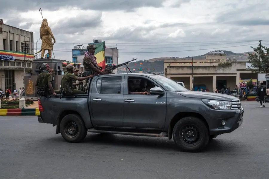 Members of the Amhara militia ride in the back of a pick up truck in the city of Gondar, Ethiopia, on January 17, 2022, as the city prepares to the celebration of Timkat. (Photo by EDUARDO SOTERAS / AFP) , AFP