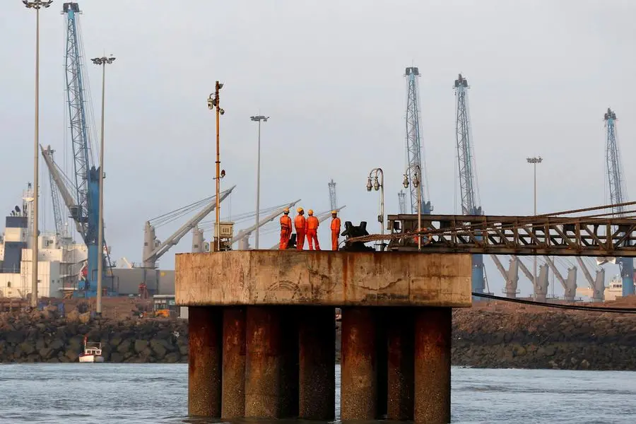 FILE PHOTO: Workers wait for a cargo ship to beach at Mundra Port, operated by Adani Ports and Special Economic Zone Ltd, in the western Indian state of Gujarat April 2, 2014. REUTERS/Amit Dave/File Photo Image used for illustrative purpose. , Reuters