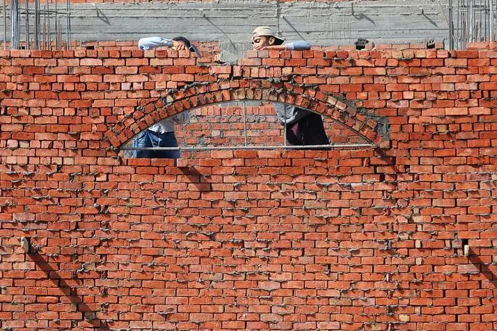 Construction workers are seen at new houses on the outskirts of Cairo, Egypt, October 21, 2019. , Shokry Hussien 