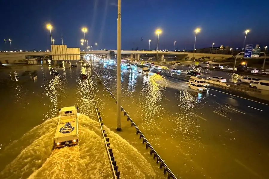 Vehicles adrive on flooded streets following heavy rains in Dubai on April 17, 2024. Dubai, the Middle East's financial centre, has been paralysed by the torrential rain that caused floods across the UAE and Bahrain and left 18 dead in Oman on April 14 and 15. (Photo by Giuseppe CACACE / AFP)