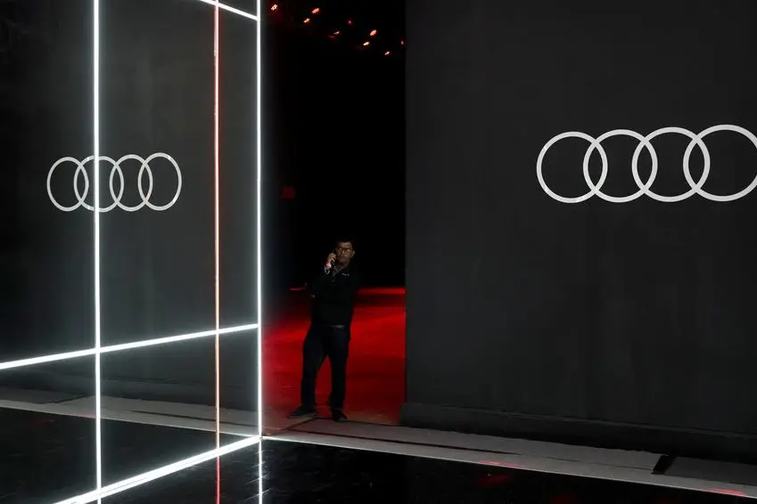 A man stands besides a logo of German automobile manufacturer Audi ahead of the launch of the Audi Q8 e-tron and the Audi Q8 Sportback e-tron electric sport utility vehicle (SUV) in Mumbai, India, August 18, 2023. REUTERS/Francis Mascarenhas , Reuters/REUTERS