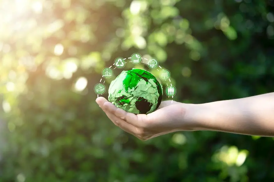 Businessman holding green scrap paper ball with world map and environment icon such as carbon reduction green factory recycle and solar cell for zero carbon emission credit to prevent global warming. Getty Images Image used for illustrative purpose , Getty Images