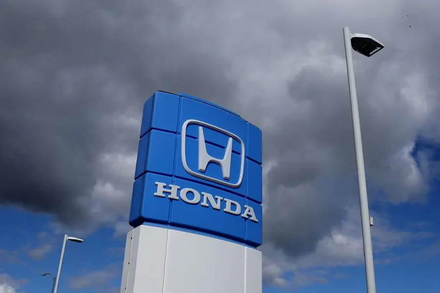 Honda posts record profit, issues cautious forecasts