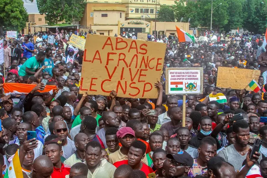 Thousands of anti-sanctions protestors gather in support of the putschist soldiers in the capital Niamey, Niger August 3, 2023. The sign reads \"Down with France long live CNSP\". REUTERS/Mahamadou Hamidou , Reuters