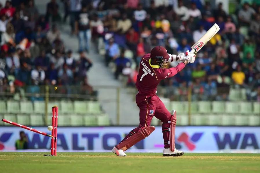 West Indies cricketer Marlon Samuels is clean bowled by Bangladesh cricketer Mohammad Saifuddin during the third one-day international (ODI) between Bangladesh and West Indies at the Sylhet International Cricket Stadium in Sylhet on December 14, 2018. (Photo by MUNIR UZ ZAMAN / AFP)