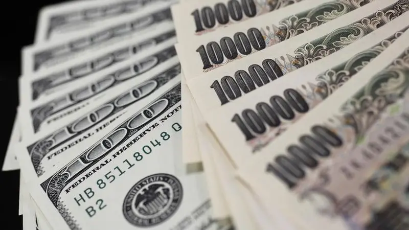 Dollar holds gains; yen on guard ahead of BOJ decision