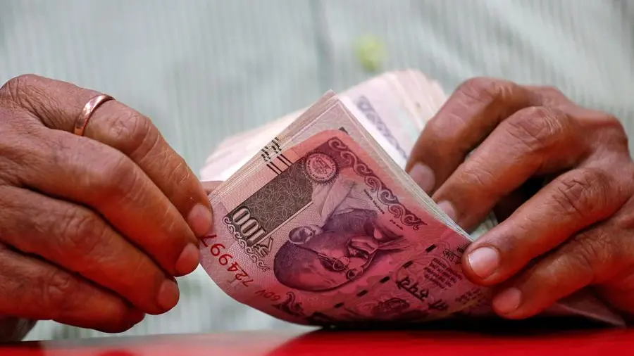 Rupee hits record low, RBI intervention averts fall past 92