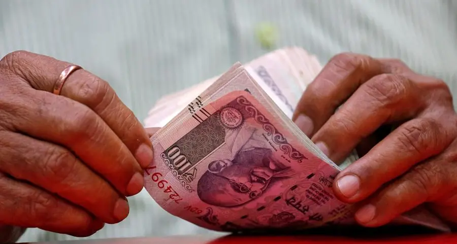 Rupee hits record low, RBI intervention averts fall past 92