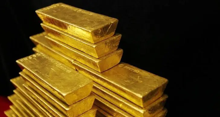 Gold subdued as dollar firms, investors seek more Fed cues