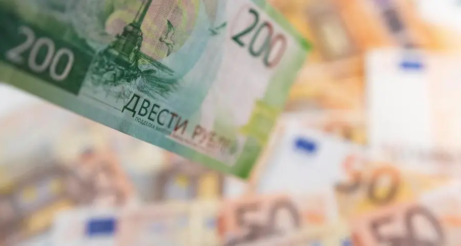 Russian rouble firms as tax payments peak