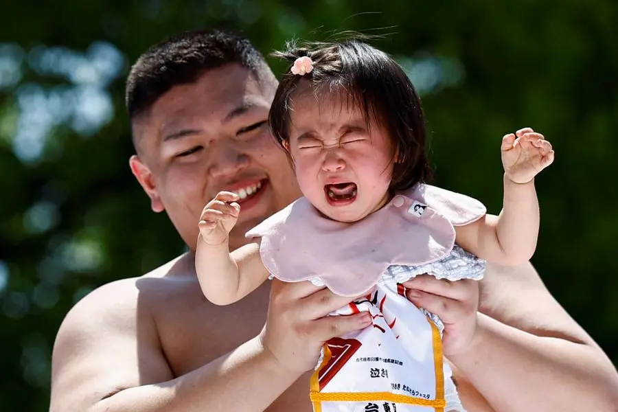 100 crying babies face off at sumo festival
