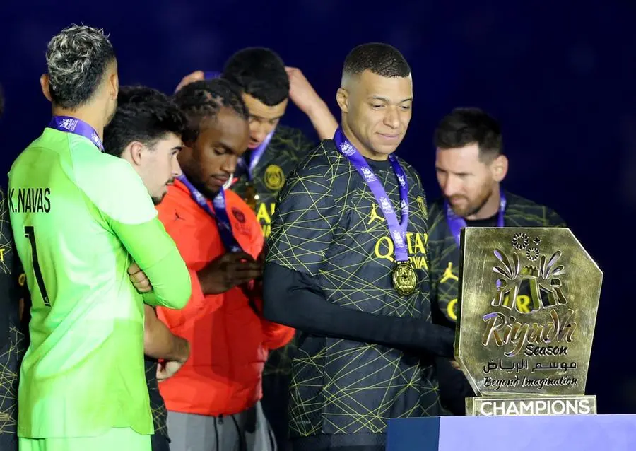 Soccer Football - Friendly - Saudi Pro League XI v Paris St Germain - King Fahd International Stadium, Riyadh, Saudia Arabia - January 19, 2023 Paris St Germain's Kylian Mbappe celebrates winning the match with a trophy REUTERS/Ahmed Yosri