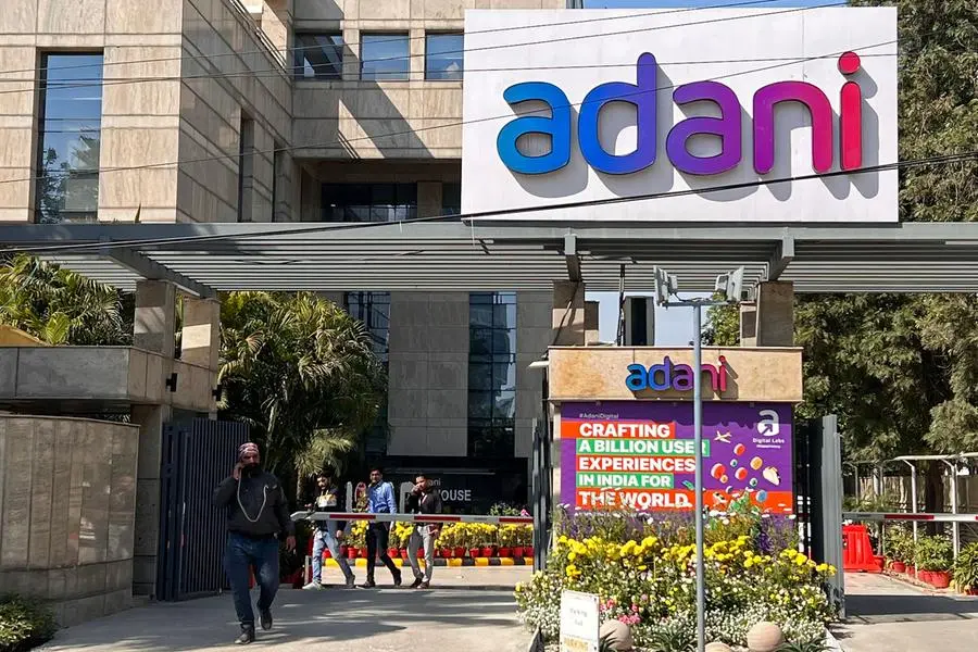 Employees walk past the Adani House corporate building at the institutional area in Gurugram on February 8, 2023. - Shares in the flagship firm of troubled Indian conglomerate Adani rose almost 15 percent on February 7, clawing back some of its recent huge losses after saying it would repay more than $1 billion in loans. (Photo by Sajjad HUSSAIN / AFP) , Agence France-Presse (AFP)/AFP