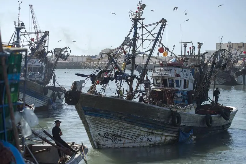 (FILES) A fisherman rests on his boat in the harbour of the Moroccan-controlled Western Sahara\\'s main city of Laayoune on November 3, 2018. Morocco will assess its cooperation with the European Union in the field of fisheries in the light of its interests, as the expiry of a protocol between the two parties approaches, the renewal of which is linked to the conflict of Western Sahara. (Photo by FADEL SENNA / AFP) , Agence France-Presse (AFP)/AFP